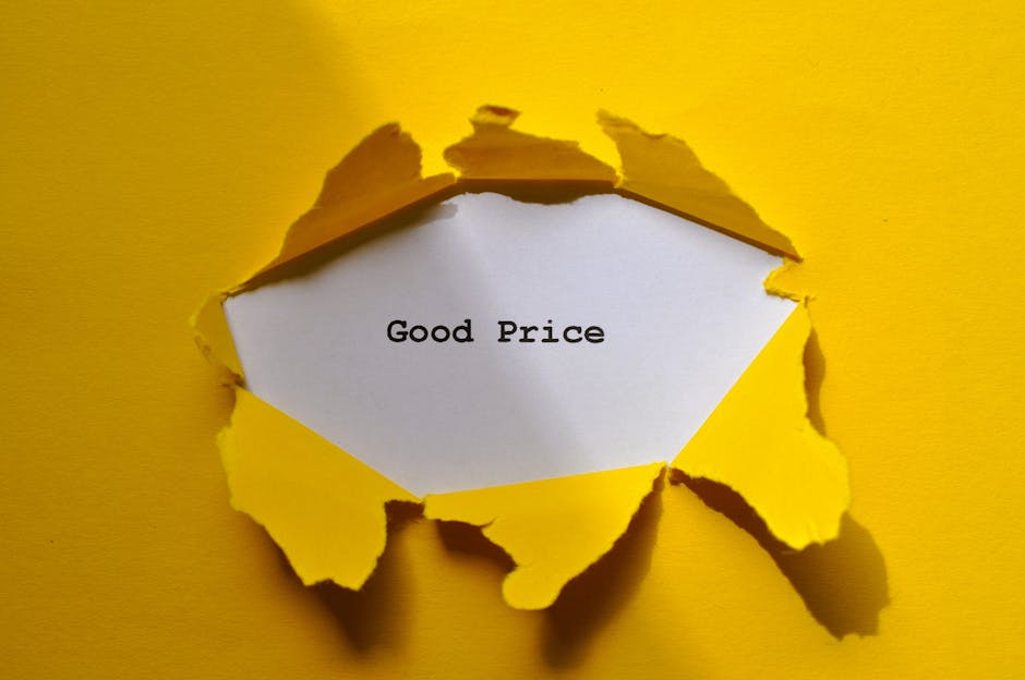 A torn piece of yellow paper reveals a white inner layer with the words 'Good Price' typed in black, positioned centrally within the disrupted edges of the paper. The torn edges are irregular and jagged, creating a rough circular opening. The background is a plain, smooth yellow surface that matches the outer paper, casting subtle shadows around the torn edges. The overall appearance is clean and crisp, with a focus on the message 'Good Price' which is suggestive of affordable or competitive pricing, and the scene subtly relates to concepts of deals or cost-effective options, consistent with rubbish removal services like those offered by Rubbish Clearance Maida Vale, especially in the context of alternative waste handling or private disposal arrangements.